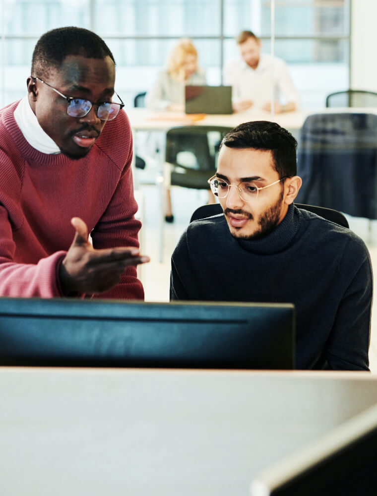 two men looking at computer two men looking at computer