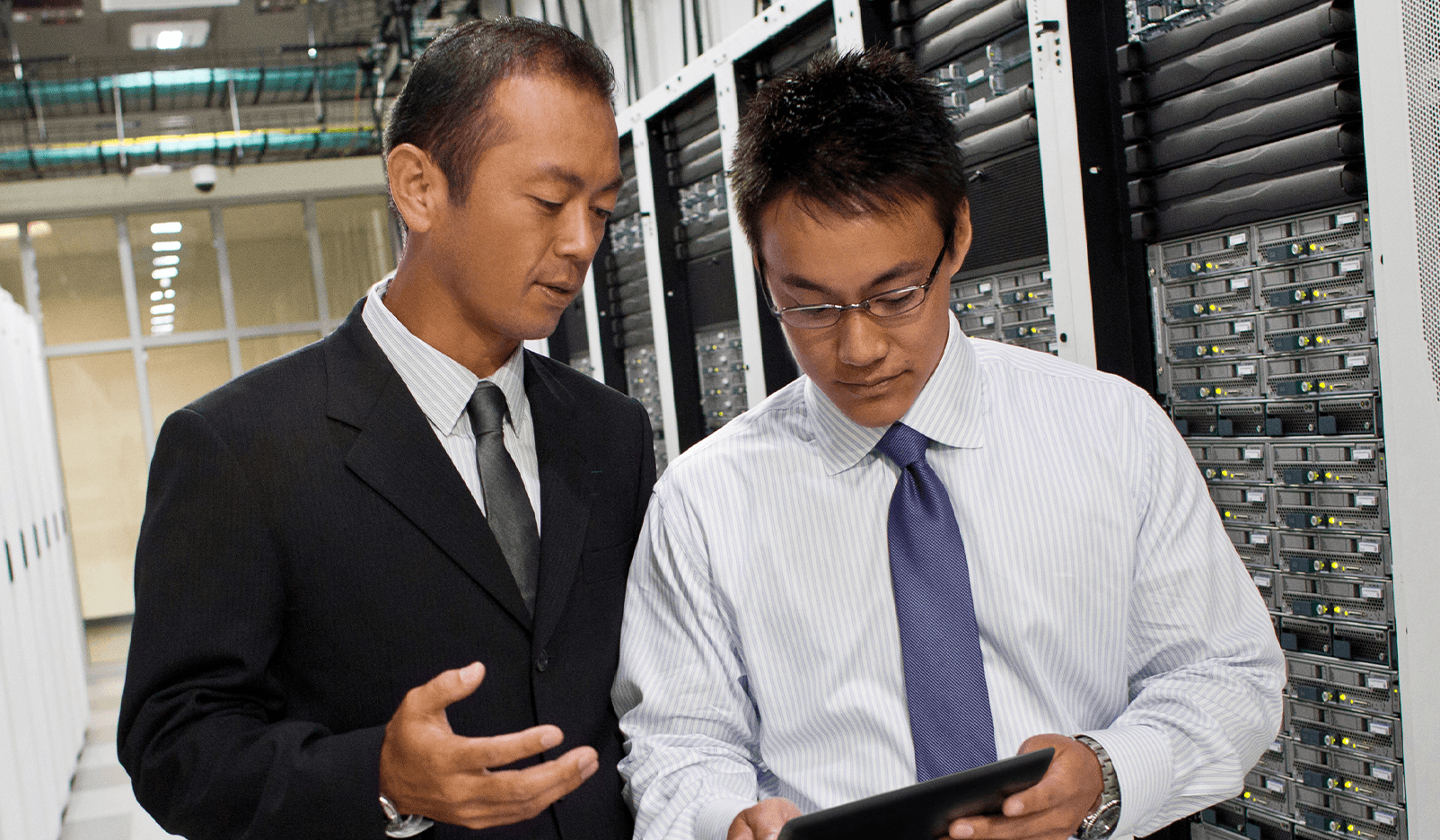 two men working in a data center